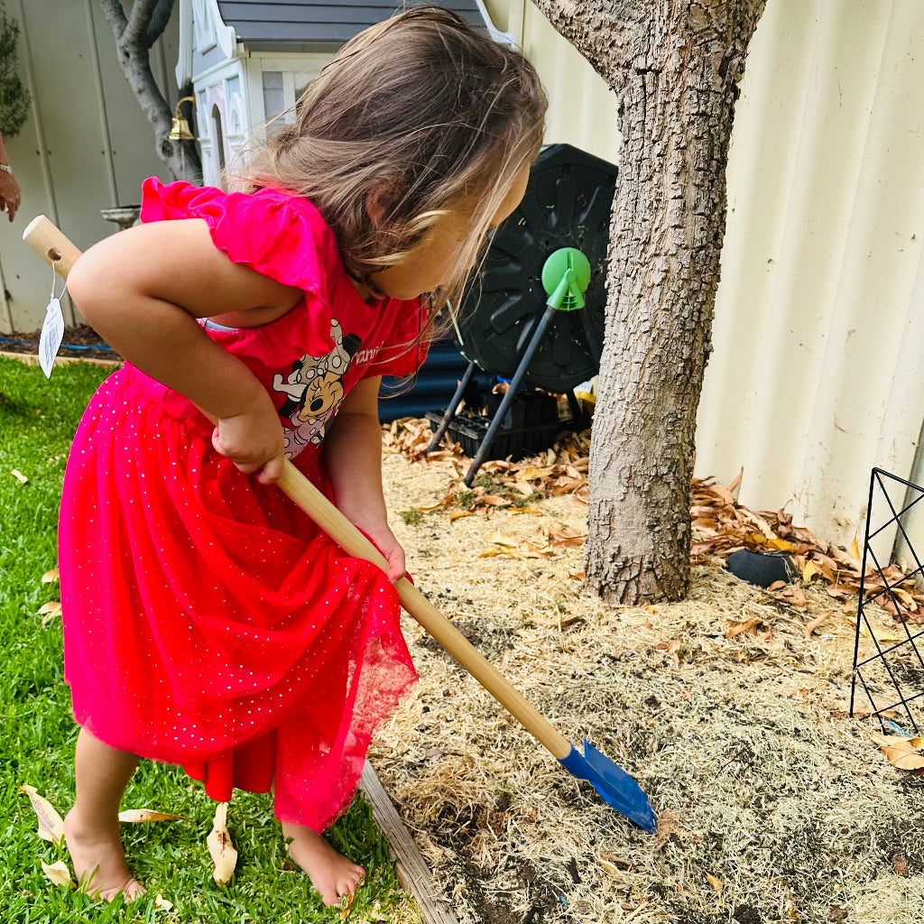 Child using Ryset Kids Long Handle Shovel.