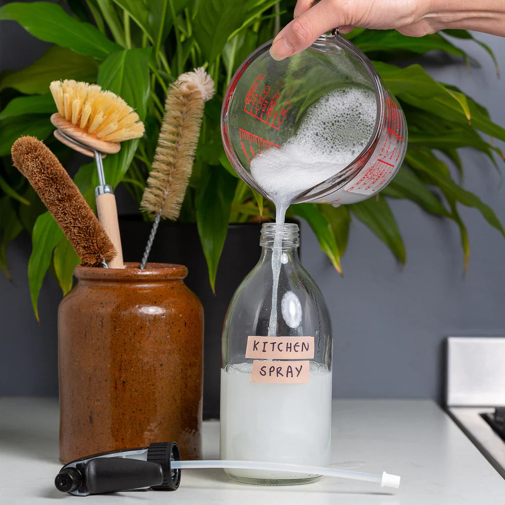 Pouring the Made Up Ethique Kitchen Spray Concentrate into a Spray Bottle. 